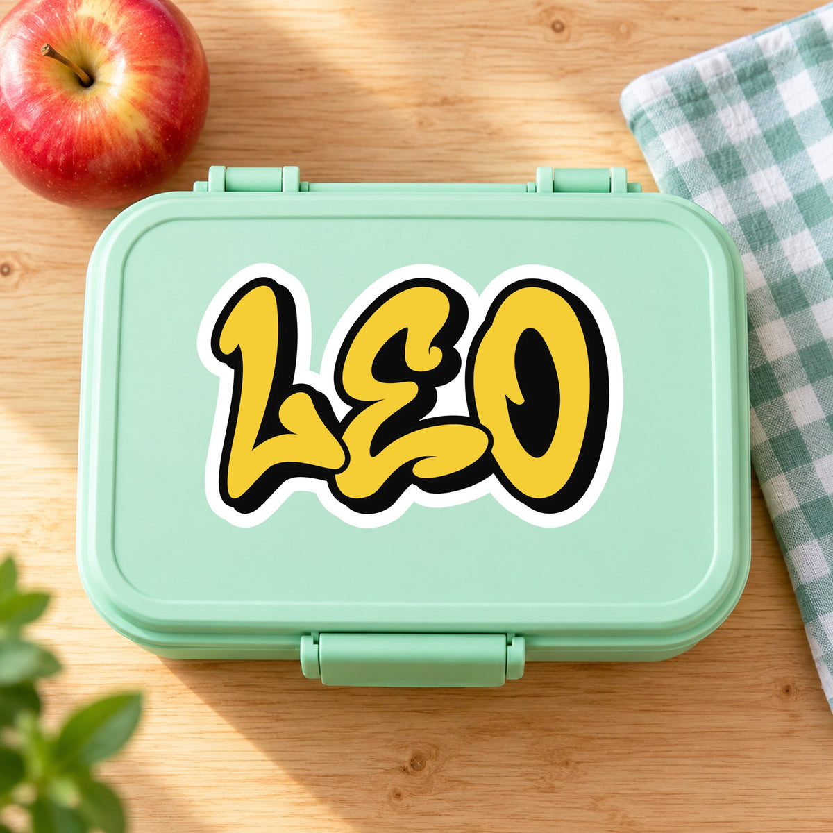 Graffiti name sticker applied to a school lunchbox lid