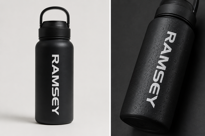 Matte black drink bottle with a personalised name decal in white lettering, shown front-on and in close-up
