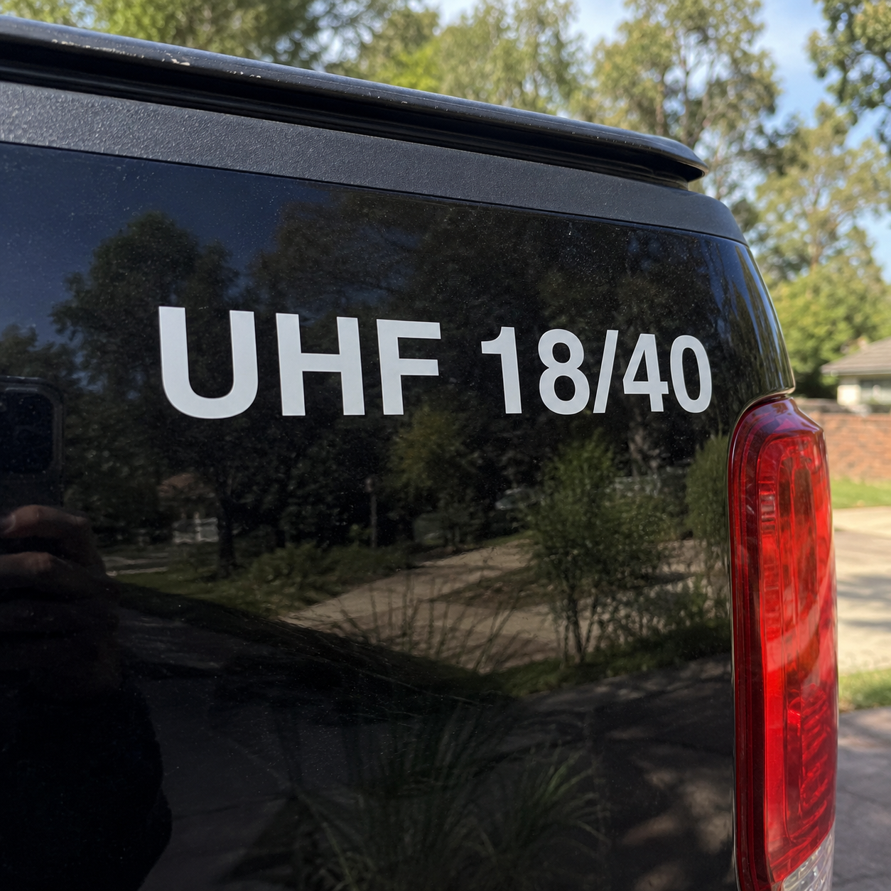 White UHF channel decal applied to the rear tailgate of a black ute