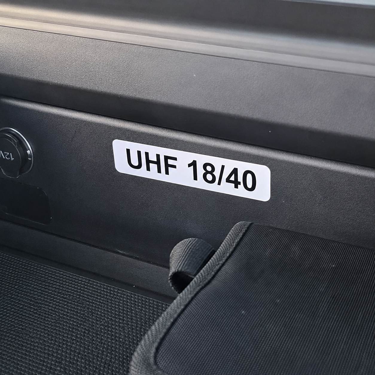 UHF channel decal with black lettering on white vinyl applied to a 4WD interior panel