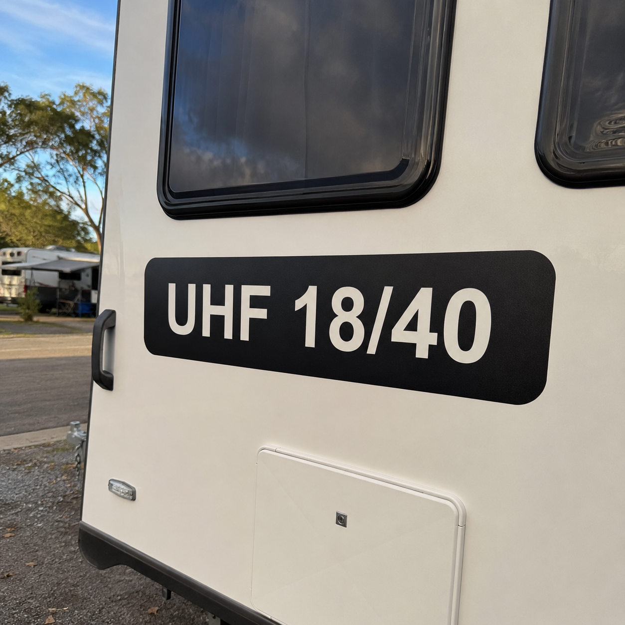 UHF channel decal with cut-out background fitted to the rear of a white caravan