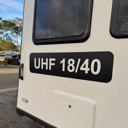 UHF channel decal with cut-out background fitted to the rear of a white caravan