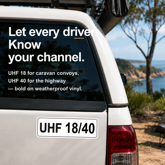 UHF 18/40 channel decal on the rear window of a white ute parked by the coast