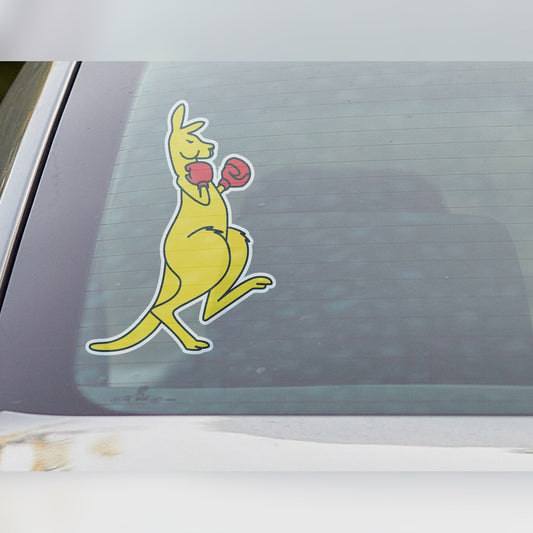 Boxing kangaroo decal – yellow kangaroo with red boxing gloves and a thin white outline on a car rear window