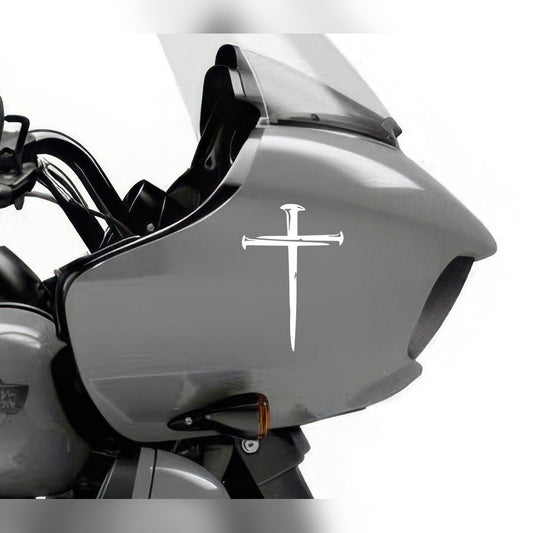 Cross decal – white nail cross on the grey fairing of a motorcycle