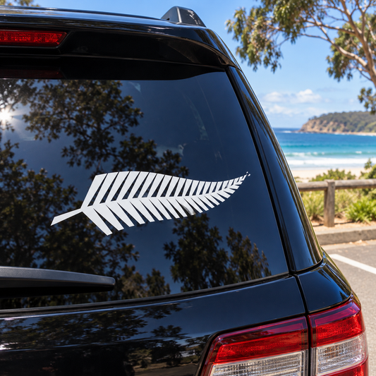 White silver fern decal on a black SUV rear window