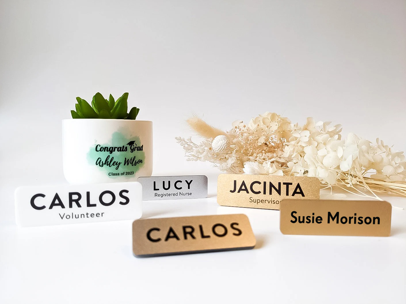 Name tags for volunteers and staff with decorative plants on a light background