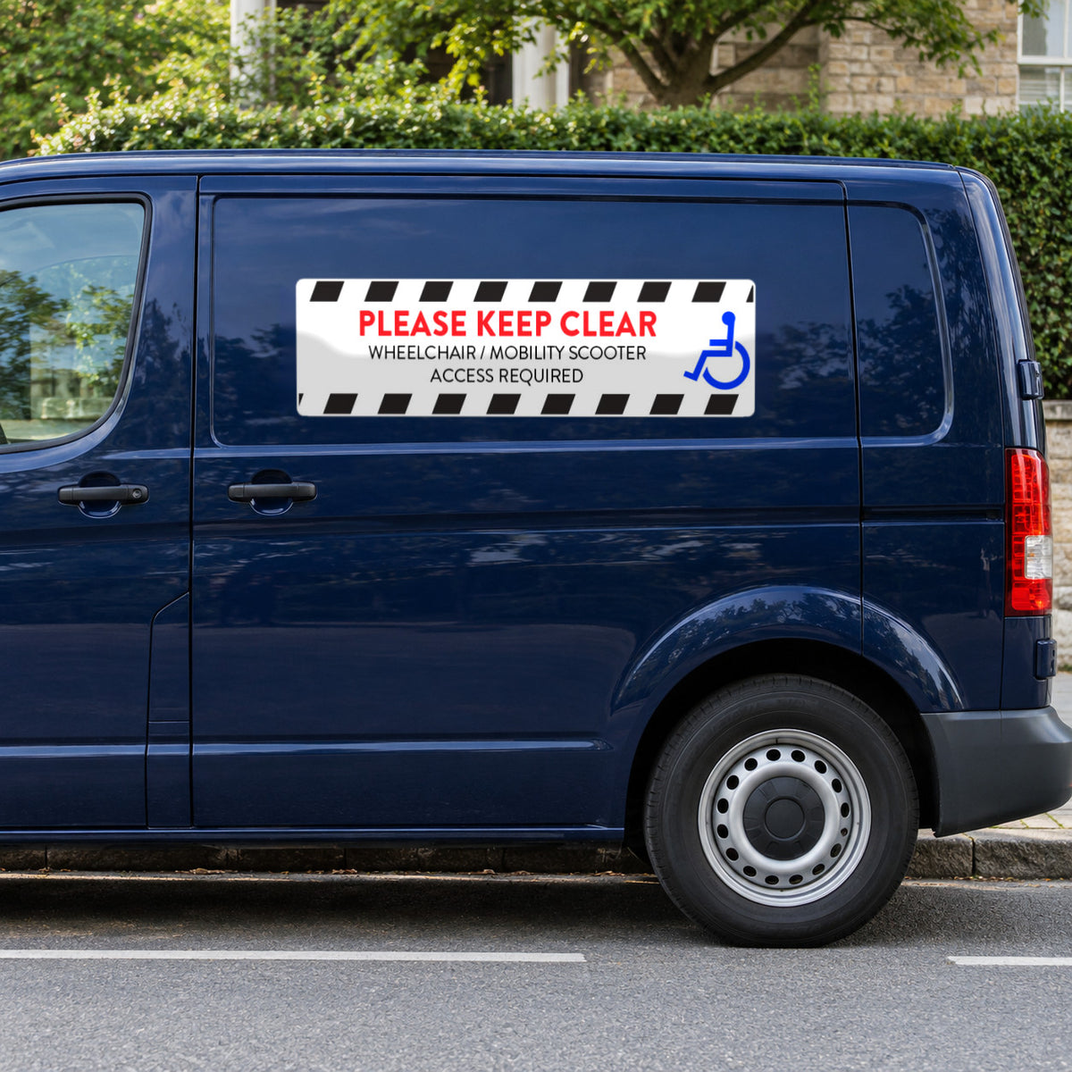 Option 4 white decal with black hazard stripes, a blue wheelchair symbol and red PLEASE KEEP CLEAR, WHEELCHAIR / MOBILITY SCOOTER ACCESS REQUIRED, on the sliding door of a navy van.