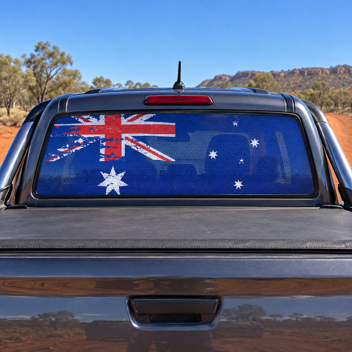 Distressed Australian flag one-way vision decal on a grey 4x4 ute rear window
