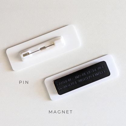 Badge reverse showing the pin bar and the magnetic bar