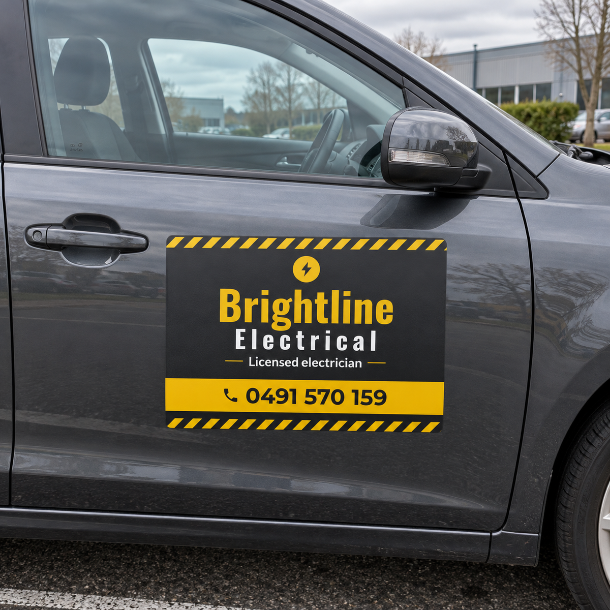 Printed car door magnet for an electrician on a dark grey hatchback