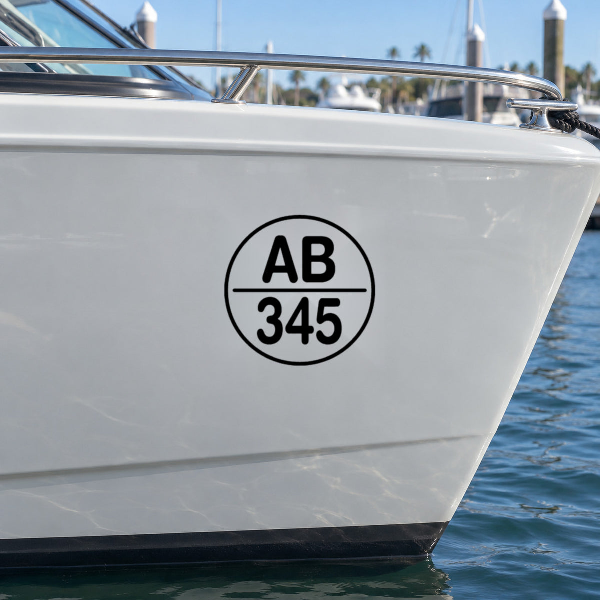 Black round boat rego decal, design Option 3, on a light grey boat hull