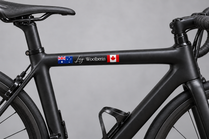 Two flag name decal on a black bicycle frame – painted-on look without clear vinyl edges