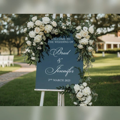 Personalised wedding sign – white welcome message and names on a navy board, on an easel with white roses