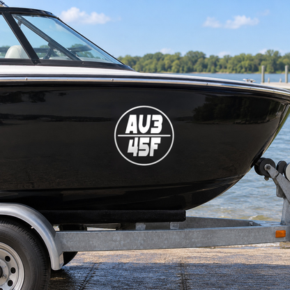 White round boat rego decal, design Option 4, on a black boat hull
