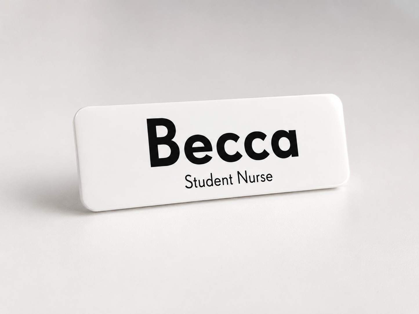 Name tag with 'Becca Student Nurse' text on a white background