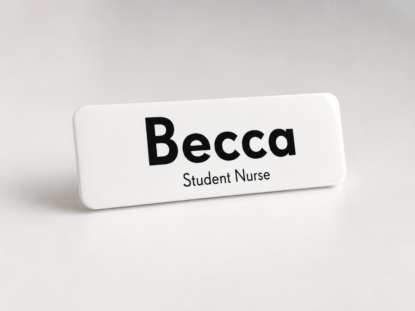 Name tag with 'Becca Student Nurse' text on a white background